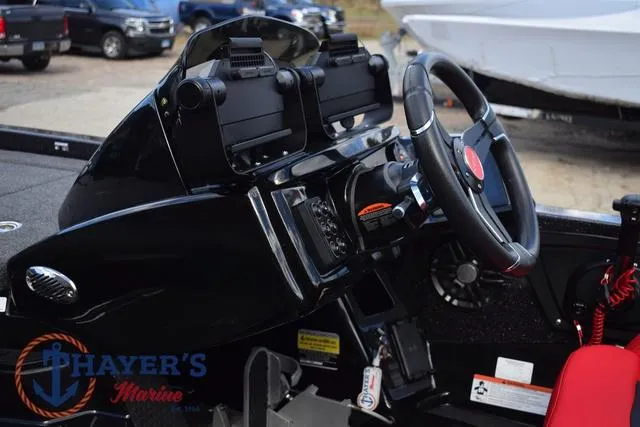 Slide: The Image of 2024 Ikon Boats LX21 dashboard with steering wheel and controls, displayed at Thayer's Marine. - 15