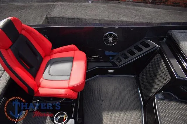 Slide: The Image of 2024 Ikon Boats LX21 interior with red and black seating, speaker, and storage compartments. - 16