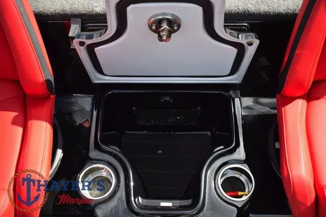 Slide: The Image of 2024 Ikon Boats LX21 interior with open storage compartment and red seating. - 18