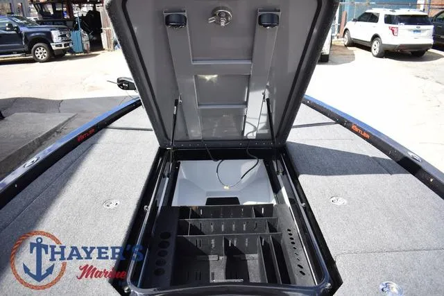 Slide: The Image of 2024 Ikon Boats LX21 open storage compartment on deck at Thayer's Marine. - 21