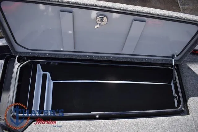 Slide: The Image of Open storage compartment of 2024 Ikon Boats LX21, featuring secure lock and spacious interior. - 23