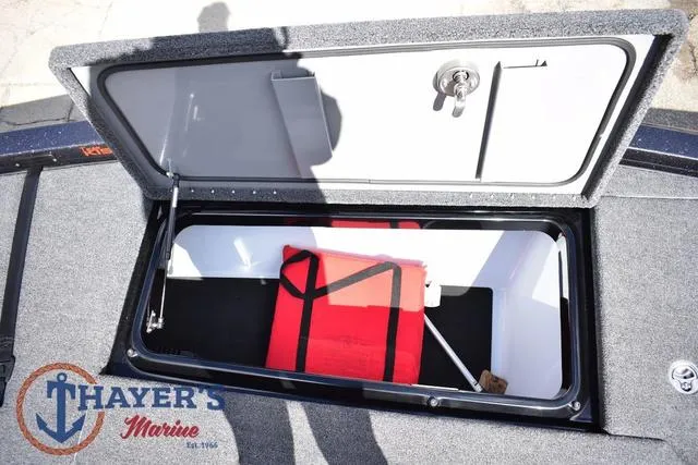 Slide: The Image of Open storage compartment on 2024 Ikon Boats LX21, featuring a red life jacket inside. - 24