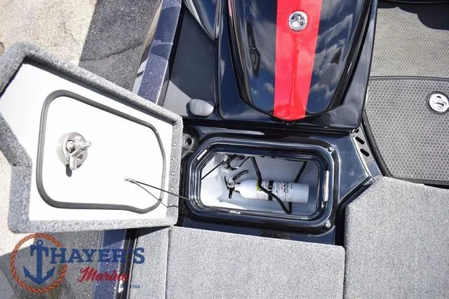 Slide: The Image of 2024 Ikon Boats LX21 storage compartment with open hatch, featuring Thayer's Marine logo. - 25