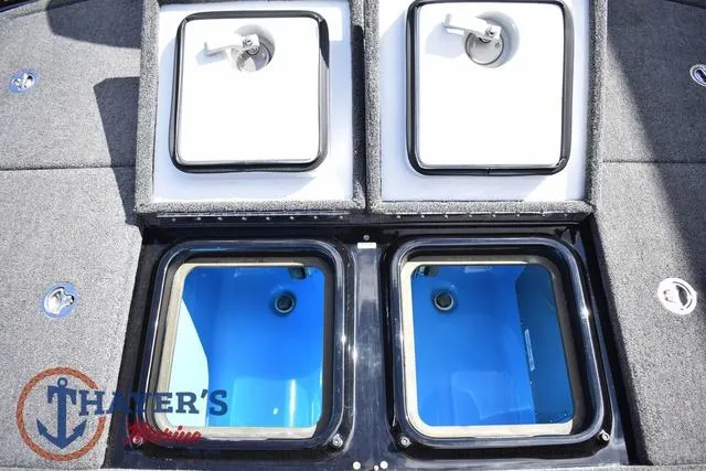 Slide: The Image of 2024 Ikon Boats LX21 storage compartments with blue interiors and secure latches. - 28