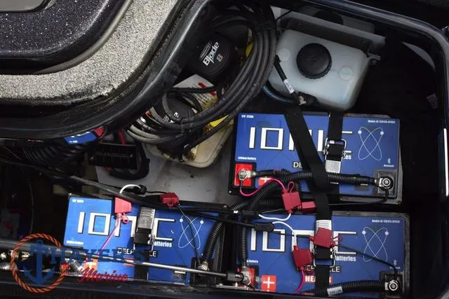 Slide: The Image of 2024 Ikon Boats LX21 battery compartment with IONIC deep cycle batteries and wiring. - 34