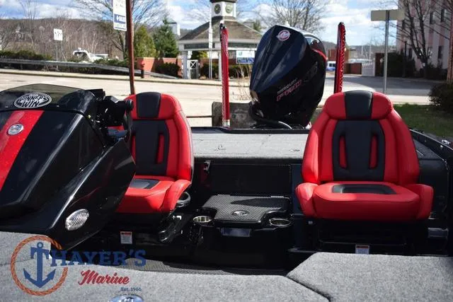 Slide: The Image of 2024 Ikon Boats LX21 interior with red and black seats, showcased at Thayer's Marine. - 36