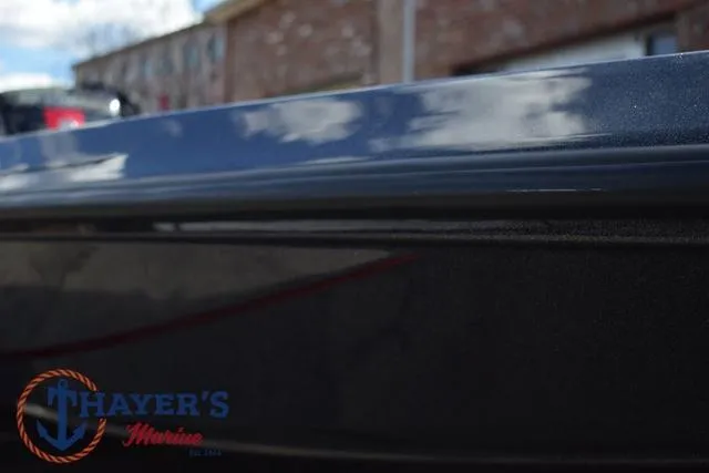 Slide: The Image of 2024 Ikon Boats LX21 close-up with Thayer's Marine logo, reflecting sky and clouds. - 39