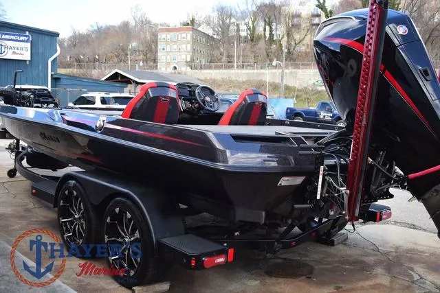 Slide: The Image of 2024 Ikon Boats LX21 with red seats and powerful outboard motor on trailer. - 5