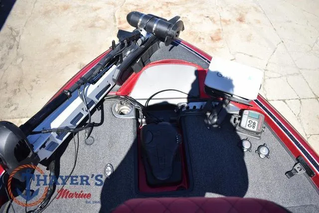 Slide: The Image of 2021 Triton 18 TrX boat deck with fishing equipment and control panel. - 11