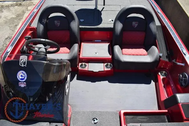 Slide: The Image of 2021 Triton 18 TrX boat interior with red and black seating, steering wheel, and console. - 13