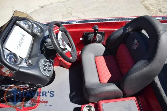 Slide: The Image of 2021 Triton 18 TrX boat cockpit with Garmin display and red-black seating. - 14