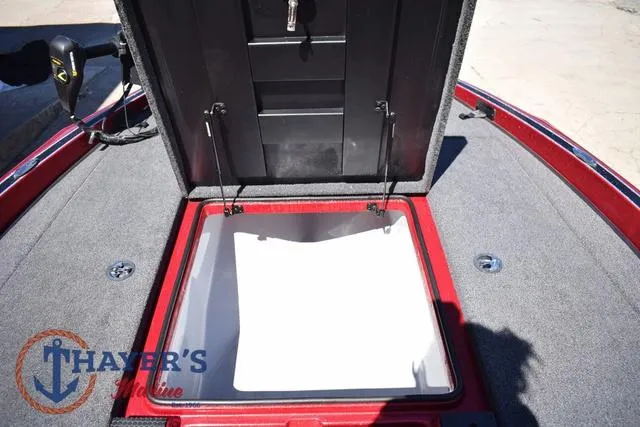 Slide: The Image of 2021 Triton 18 TrX boat storage compartment with open lid, featuring Thayer's Marine logo. - 20