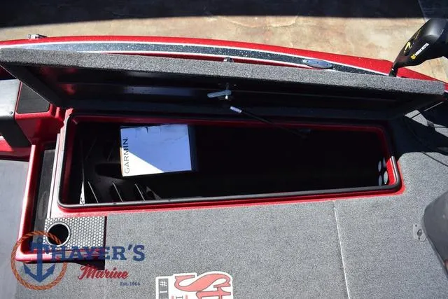 Slide: The Image of Open storage compartment on 2021 Triton 18 TrX boat with Garmin box inside. - 22