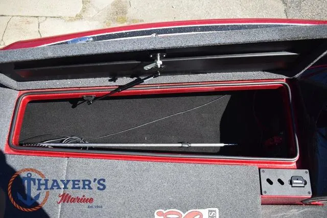 Slide: The Image of Open storage compartment of 2021 Triton 18 TrX boat at Thayer's Marine. - 23