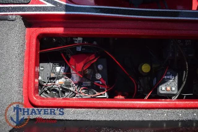 Slide: The Image of Battery compartment of a 2021 Triton 18 TrX boat with wiring and components. - 28
