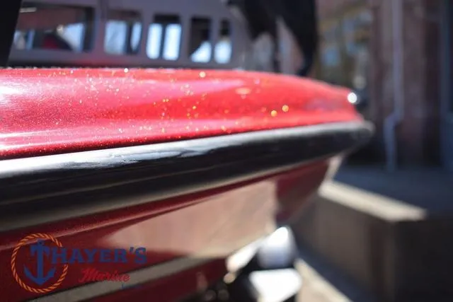 Slide: The Image of 2021 Triton 18 TrX boat with red metallic finish at Thayer's Marine. - 32