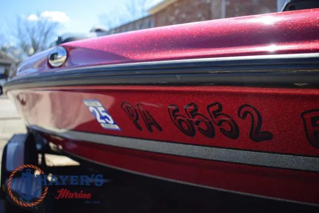 Slide: The Image of 2021 Triton 18 TrX boat in red, close-up view with registration number PA 6552. - 33