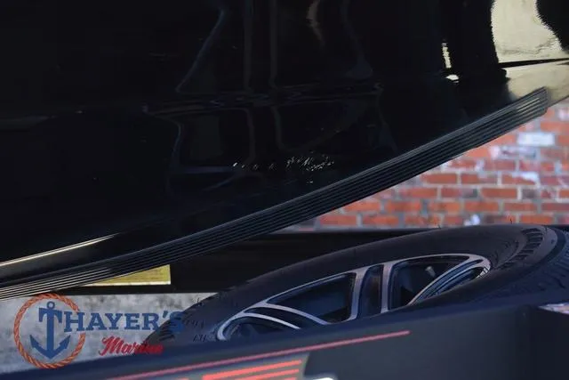 Slide: The Image of 2021 Triton 18 TrX boat detail with trailer tire and Thayer's Marine logo. - 34