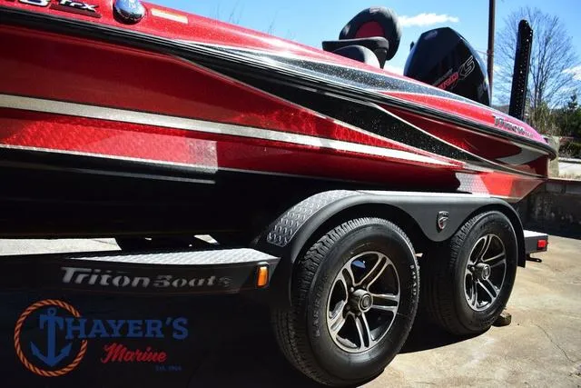 Slide: The Image of Red 2021 Triton 18 TrX boat on trailer at Thayer's Marine dealership. - 38