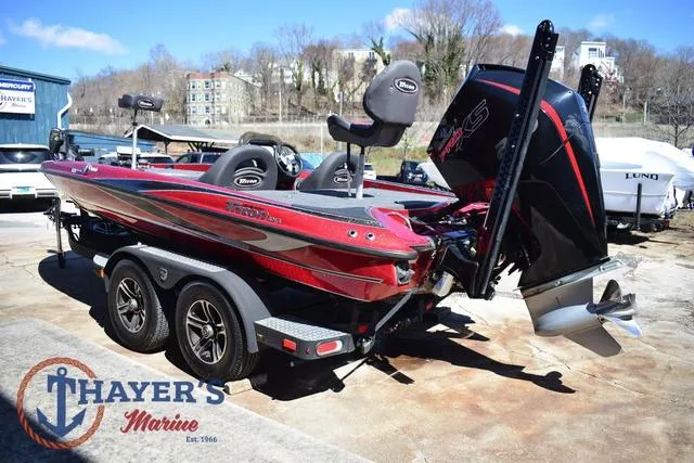 Slide: The Image of 2021 Triton 18 TrX boat with dual seats and powerful outboard motor at Thayer's Marine. - 5
