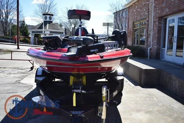 Slide: The Image of 2021 Triton 18 TrX boat on trailer, parked outside a brick building. - 7