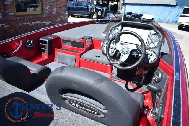 Slide: The Image of 2021 Triton 18 TrX boat interior with steering wheel and dashboard controls. - 8