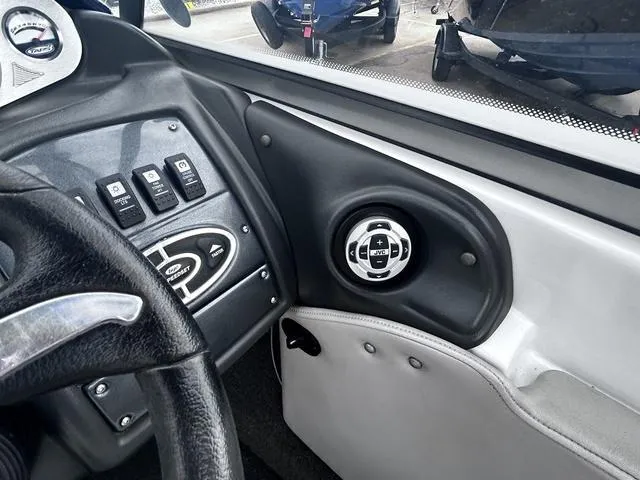 Slide: The Image of 2008 Tigé 24 VE boat dashboard with control panel and speaker. - 10