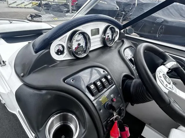 Slide: The Image of 2008 Tigé 24 VE boat dashboard with gauges, steering wheel, and control switches. - 12