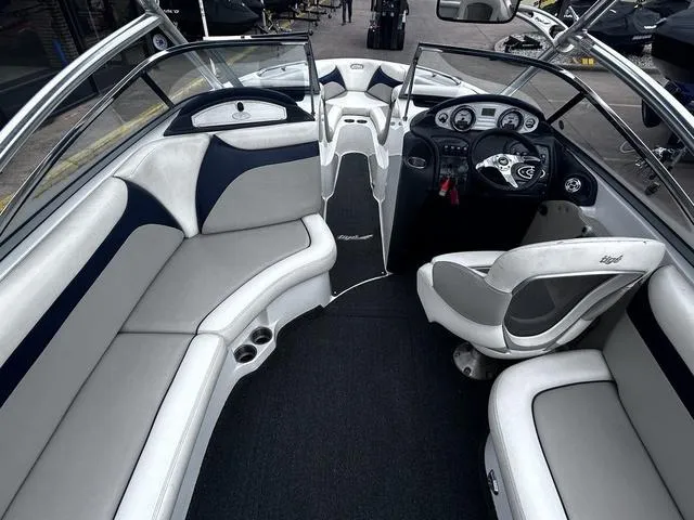 Slide: The Image of 2008 Tigé 24 VE boat interior with gray seating and modern dashboard. - 7