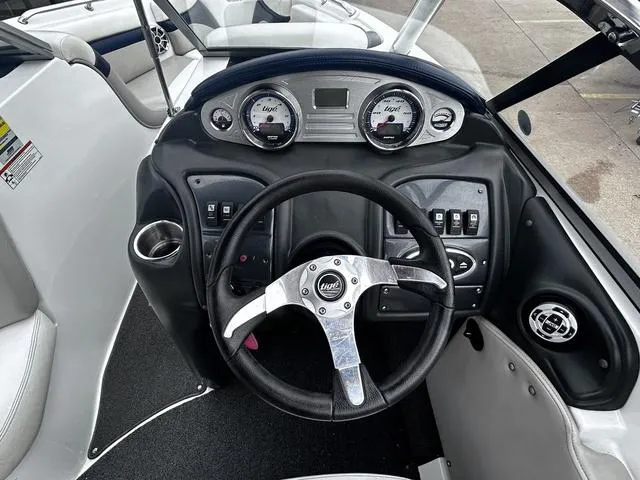 Slide: The Image of 2008 Tigé 24 VE boat dashboard with steering wheel and gauges. - 9