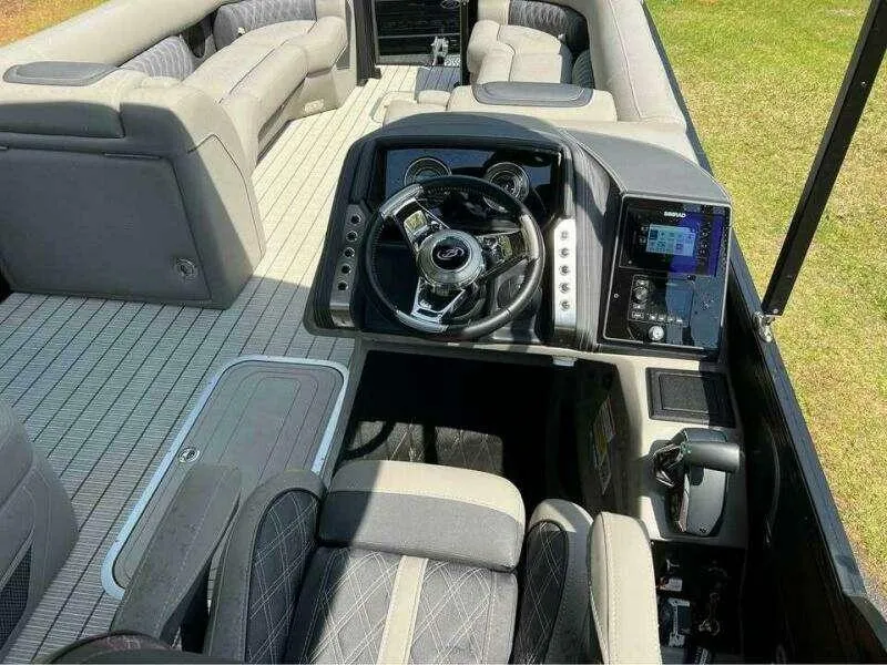 Slide: The Image of 2023 Barletta LUSSO 25U boat interior with modern dashboard and luxurious seating. - 3