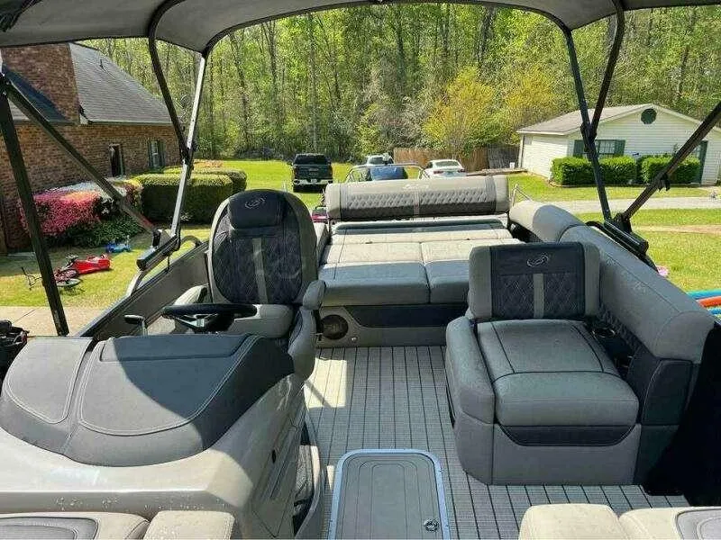Slide: The Image of 2023 Barletta LUSSO 25U pontoon boat interior with plush seating and canopy. - 4