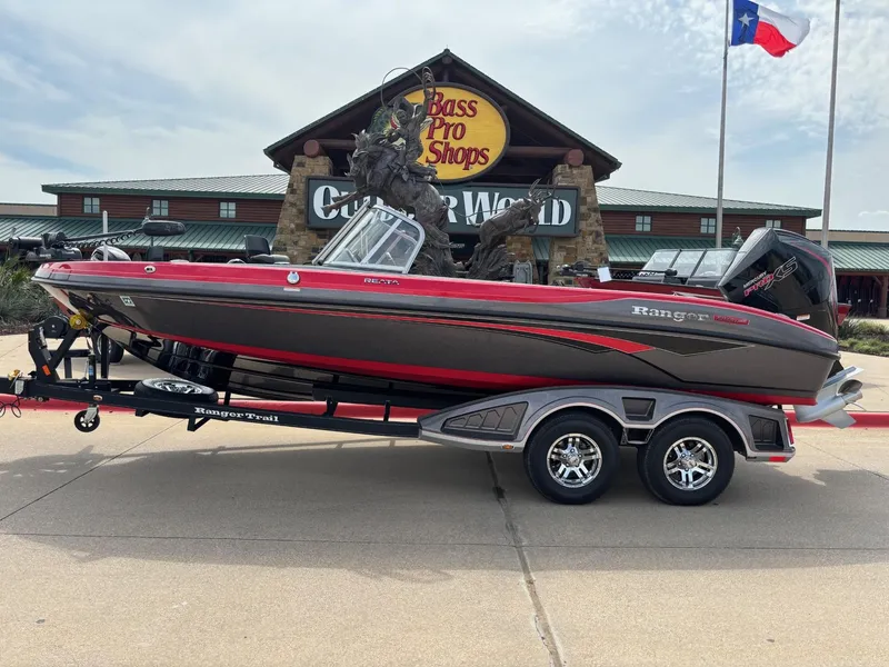 Slide: The Image of 2022 Ranger 2050MS boat on trailer outside Bass Pro Shops, Cabela's, Texas flag visible. - 1