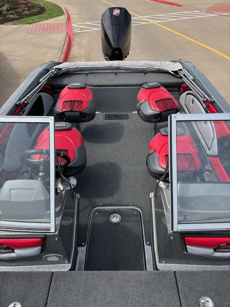 Slide: The Image of 2022 Ranger 2050MS boat interior with red and black seating, open windshield, and motor view. - 6