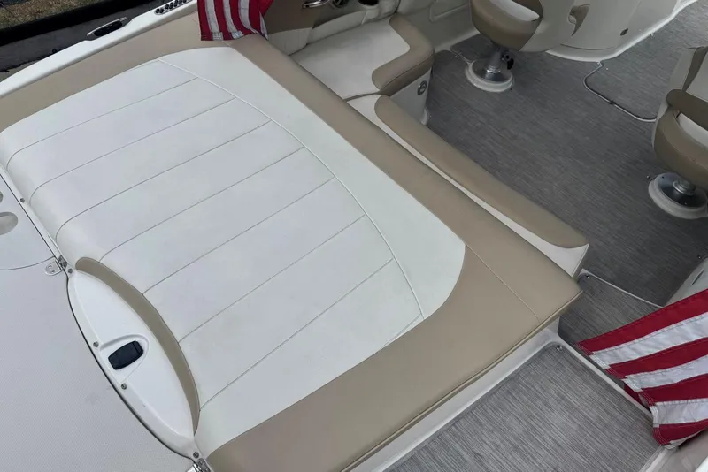 Slide: The Image of 2017 Stingray 235 LR boat interior with beige and white seating, American flag detail. - 13