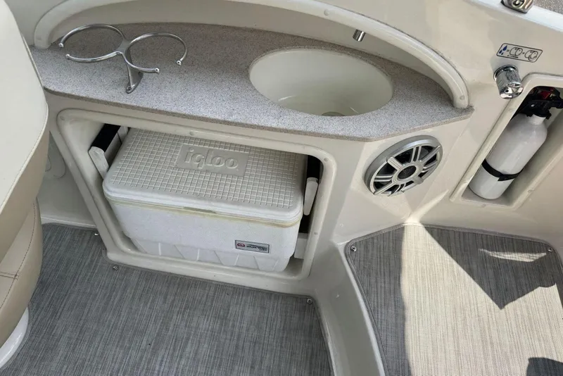 Slide: The Image of 2017 Stingray 235 LR boat interior with cooler, sink, and speaker. - 17