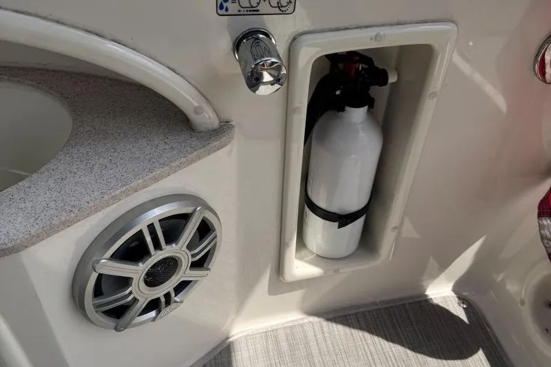 Slide: The Image of 2017 Stingray 235 LR boat interior with fire extinguisher and speaker. - 18