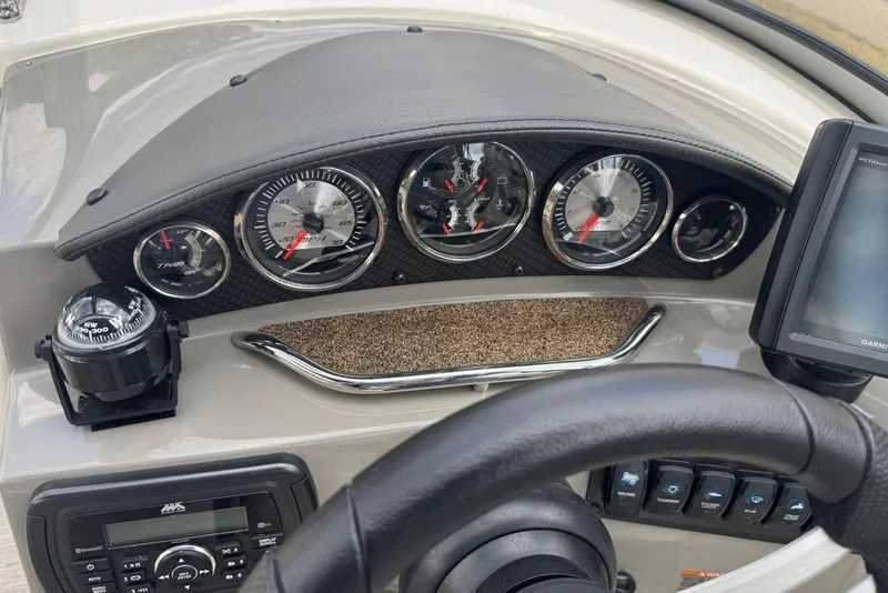 Slide: The Image of Dashboard of a 2017 Stingray 235 LR boat with gauges and navigation equipment. - 22