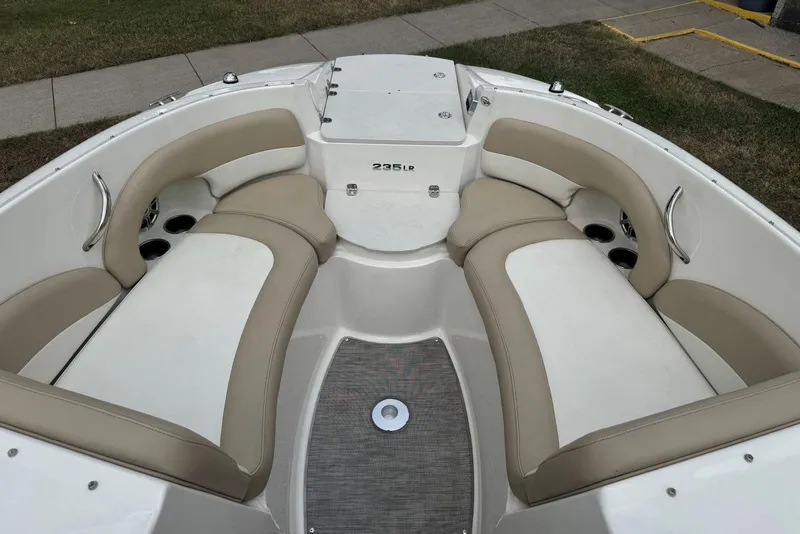Slide: The Image of 2017 Stingray 235 LR boat interior with beige and white seating. - 24