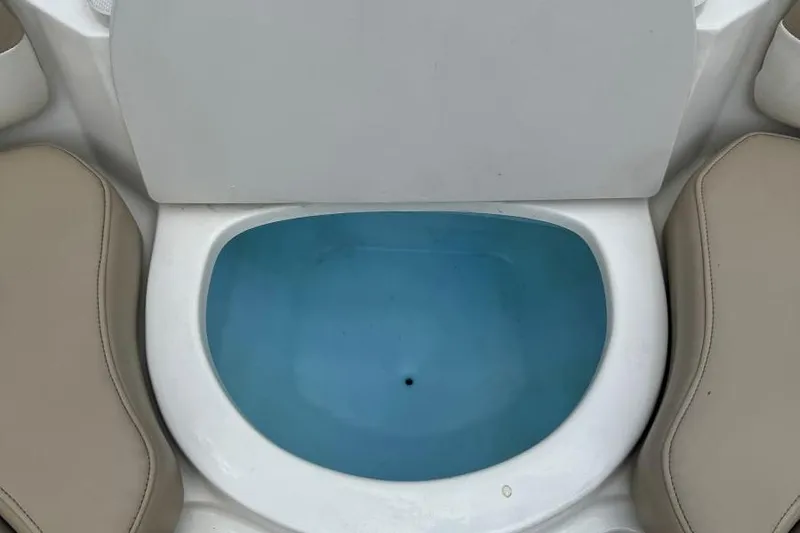 Slide: The Image of 2017 Stingray 235 LR boat cooler with blue interior and beige seating. - 28