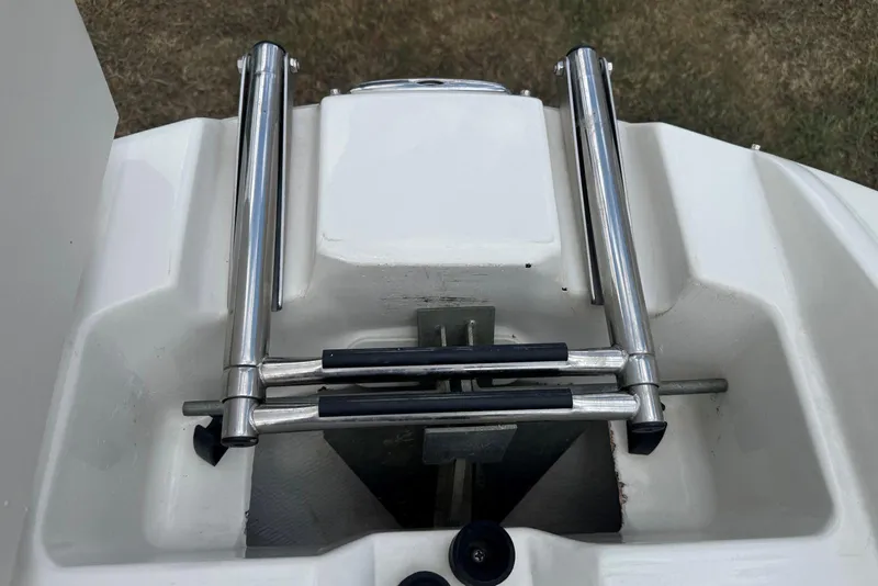 Slide: The Image of 2017 Stingray 235 LR boat ladder, stainless steel, folded on white deck. - 32