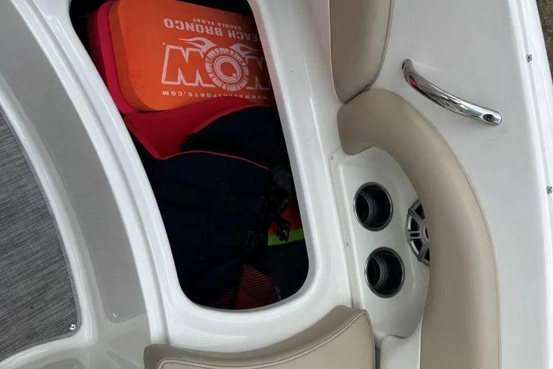 Slide: The Image of 2017 Stingray 235 LR boat interior with storage compartment and life jackets. - 33