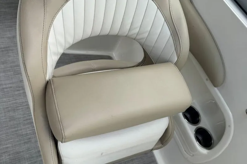 Slide: The Image of 2017 Stingray 235 LR boat seat with beige and white upholstery, featuring cup holders. - 40