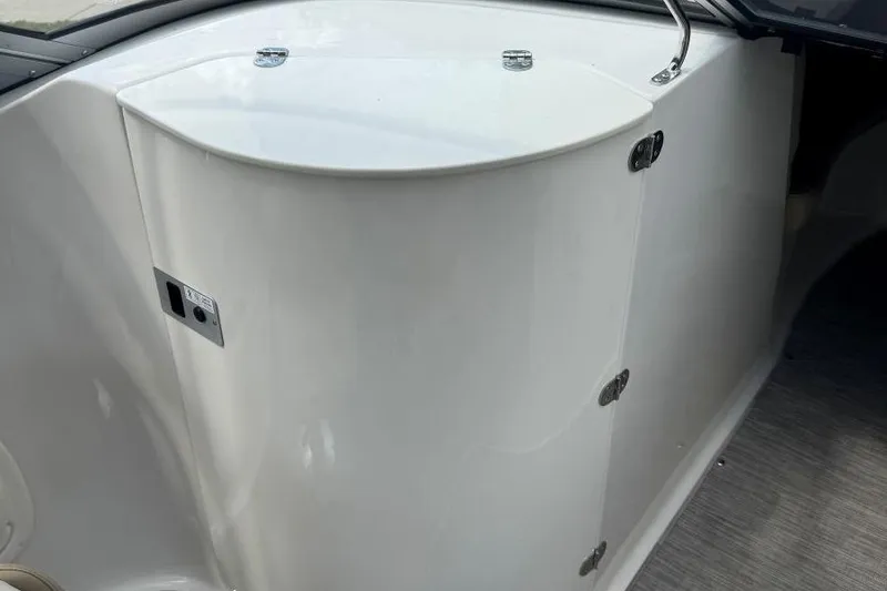 Slide: The Image of 2017 Stingray 235 LR boat interior with sleek white storage compartment. - 43
