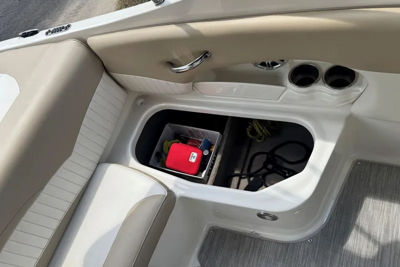 Slide: The Image of 2017 Stingray 235 LR boat interior storage compartment with safety gear and accessories. - 47