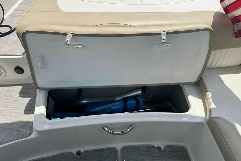 Slide: The Image of Open storage compartment in 2017 Stingray 235 LR boat, showcasing interior space. - 48