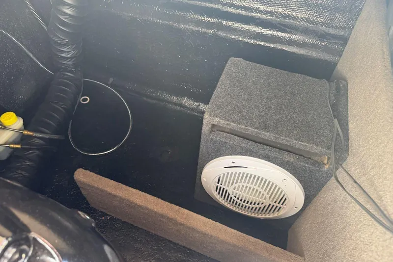 Slide: The Image of Interior of a 2017 Stingray 235 LR boat showing speaker and wiring setup. - 50