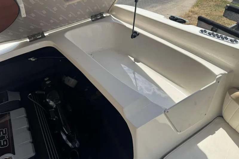 Slide: The Image of Open engine compartment of a 2017 Stingray 235 LR boat, showcasing interior details. - 52