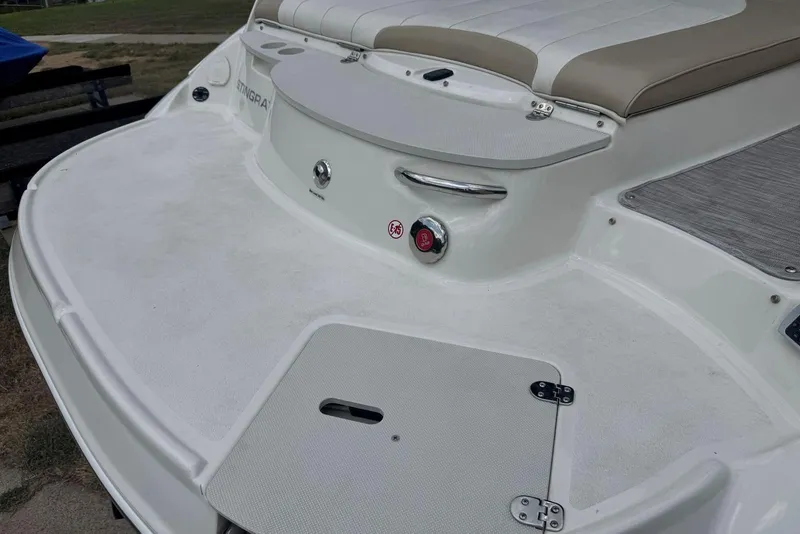 Slide: The Image of 2017 Stingray 235 LR boat deck with seating and storage compartments. - 9