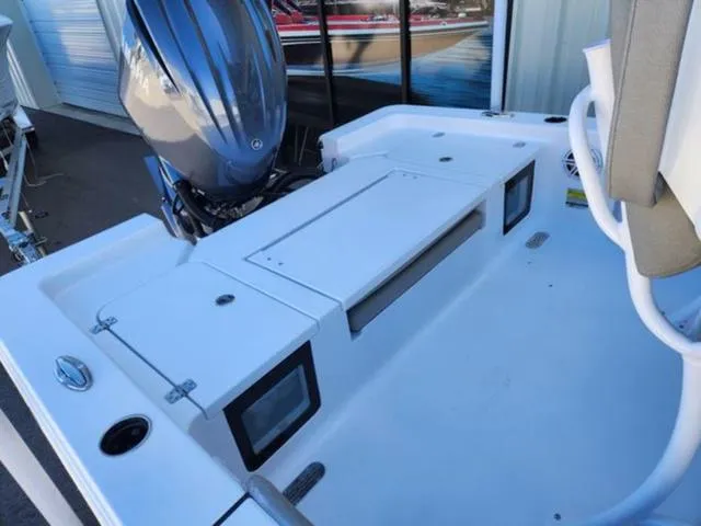 Slide: The Image of 2025 Sportsman MASTERS 247OE boat deck with engine, storage compartments, and seating area. - 11